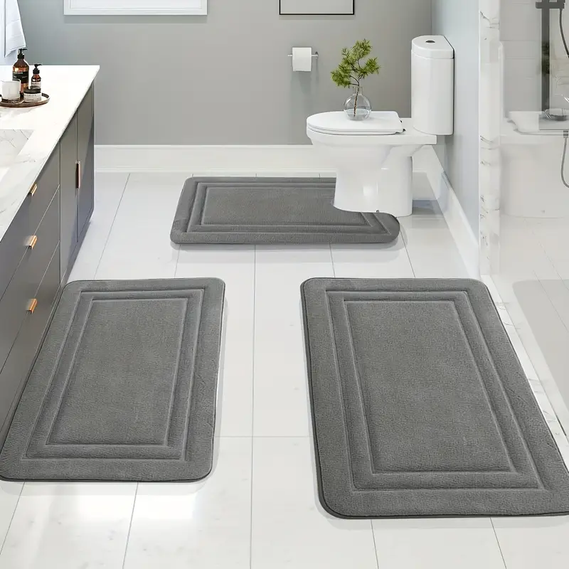 3 gray oblong mats on tiled floor